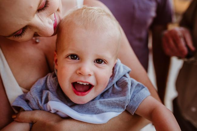 Close up of little boy smiling during an extended family photography session at The Pines Wanneroo in Perth