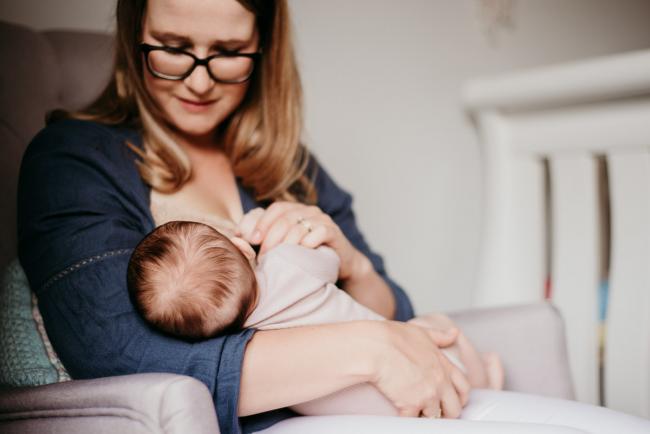 20180610-20180610-DSC_8296 mother looking down at her new baby whilst she breastfeeds during a Perth newborn photography session