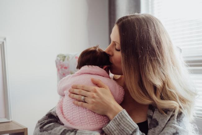 20180703-DSC_4628 Mother kissing her new baby's head during a newborn lifestyle session in Perth