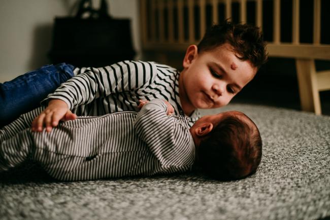 20180706-20180706-DSC_6316 Big brother laying with his new baby brother on a rug during a Perth newborn photography session