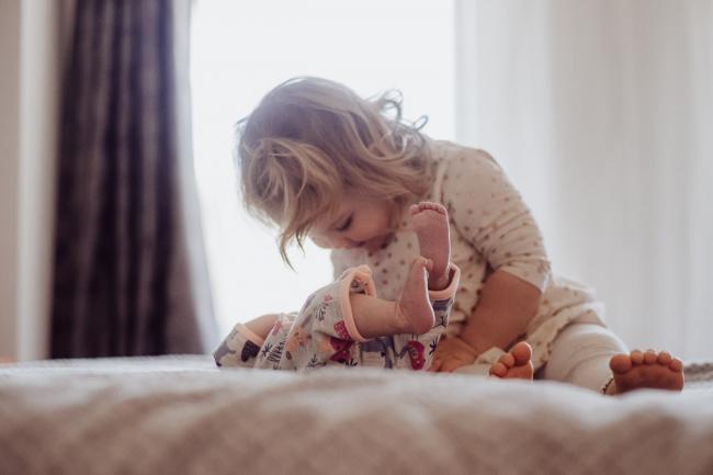 20180720-DSC_8899 Big sister looking down on her new baby sister during a lifestyle newborn session in Perth