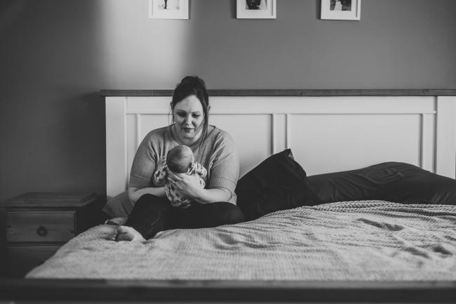20180720-DSC_9113 Black and white image of a mother smiling at her new baby on her bed during a Perth newborn lifestyle session