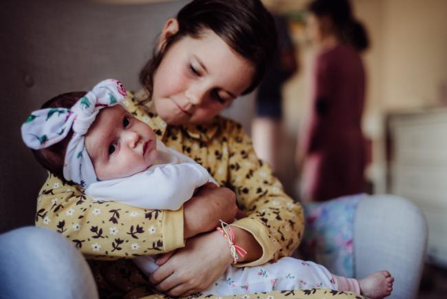 20180826-DSC_8254 Big sister holding her new baby sister during a Perth newborn photography session