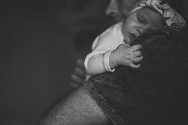 20180826-DSC_8469 Black and white image of a new baby's sleeping face and little hand resting on her daddy's shoulder during a Perth newborn lifestyle session