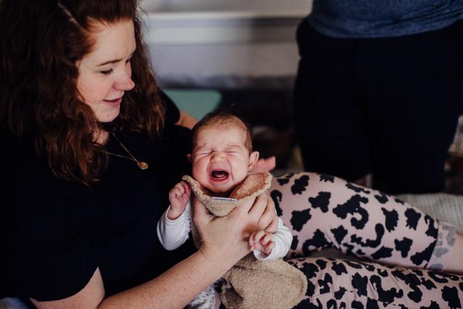 20180927-DSC_8473 Mother burping her crying newborn baby during a Perth newborn lifestyle session