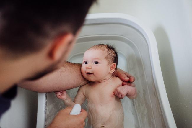 20180927-DSC_8621 New baby being bathed by her father during a newborn lifestyle photography session in Perth