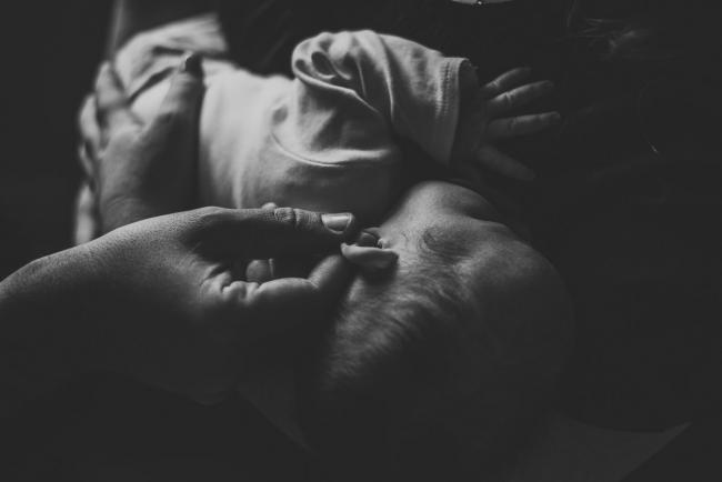 20180927-DSC_8794 Black and white image of a father playing with his new baby's ear during a lifestyle newborn photography session in Perth
