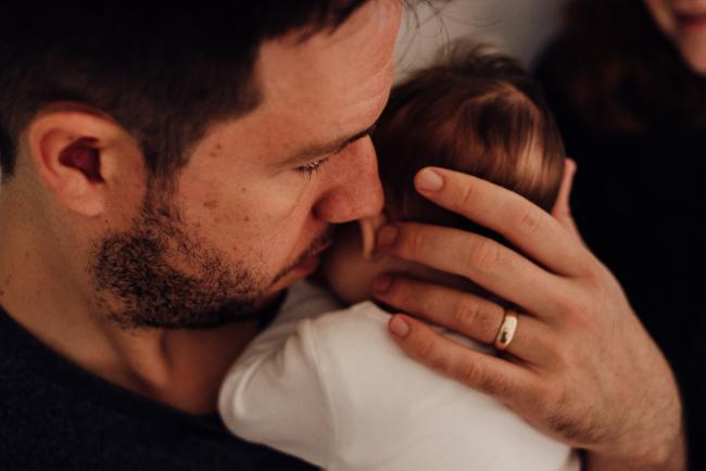 20180927-DSC_8854 Father cradling his new baby during a newborn lifestyle session in Perth