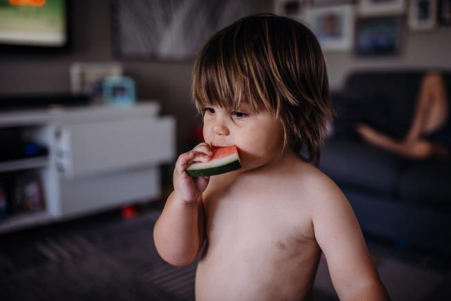 Little boy eating watermelon with Perth family photographer