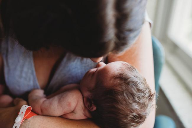 Mother touching noses with her new baby during Fresh 48 Photography Perth session