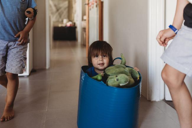 Little boy in a blue bucket with stuffed toys with Perth family photographer