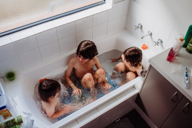 Top down image of three little boys in the bath with Perth family photographer