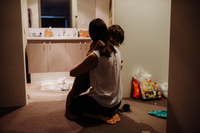 Mother and son cuddling on the floor by Perth family photographer