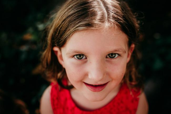 Family-Photographer-Perth-Hyde-Park-10-of-34 Close up of little girl in a red dress during a Perth family photography session at Hyde Park