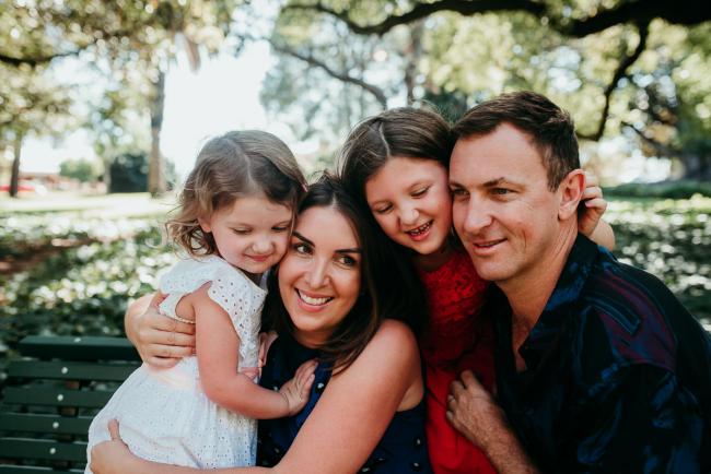 Family-Photographer-Perth-Hyde-Park-14-of-34 Close up of family of four hugging during a Perth family photography session at Hyde Park