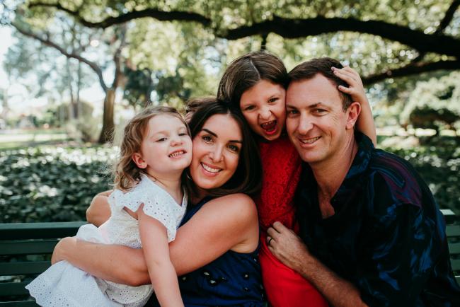 Family-Photographer-Perth-Hyde-Park-15-of-34 Close up of family of four hugging during a Perth family photography session at Hyde Park