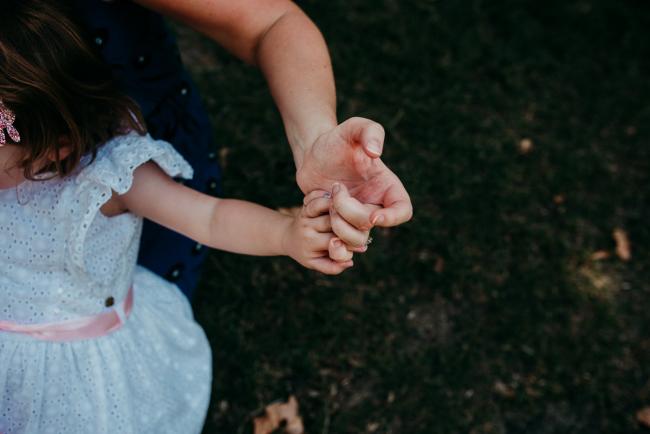Family-Photographer-Perth-Hyde-Park-16-of-34 Mother and daughter holding hands during a Perth family photography session at Hyde Park