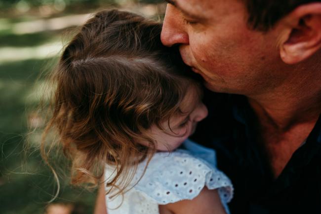 Family-Photographer-Perth-Hyde-Park-20-of-34 Close up of father kissing his daughter's head during a Perth family photography session at Hyde Park