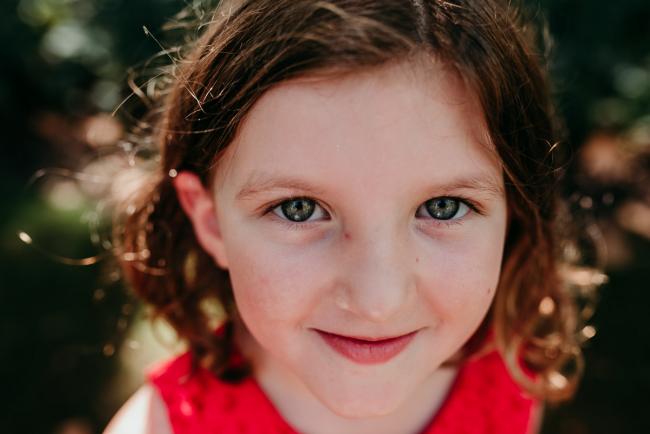 Family-Photographer-Perth-Hyde-Park-28-of-34 Close up of little girl looking at the camera during a Perth family photography session at Hyde Park