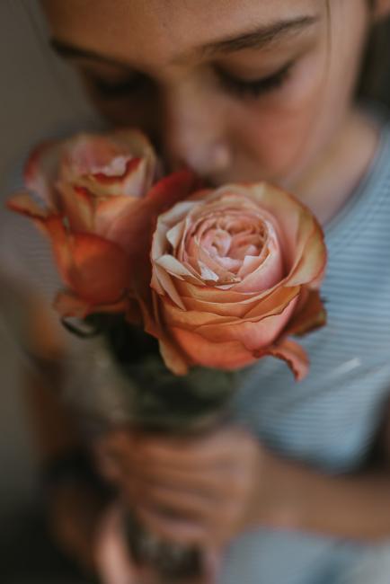 Family-Photography-Perth-4-of-25 Close up top down image of girl smelling roses with Perth family photographer