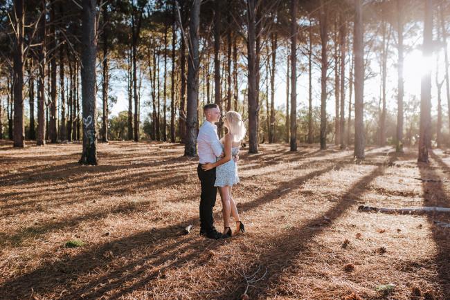 Perth-Couples-Photography-1-of-27 Couple standing and embracing in the middle of The Pines Wanneroo during a Golden Hour Perth couples photography session