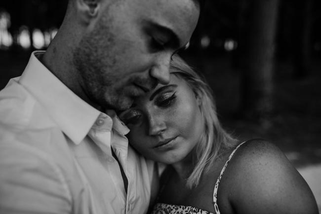 black and white image of woman leaning her head against her partners chest during a Perth couples photography session
