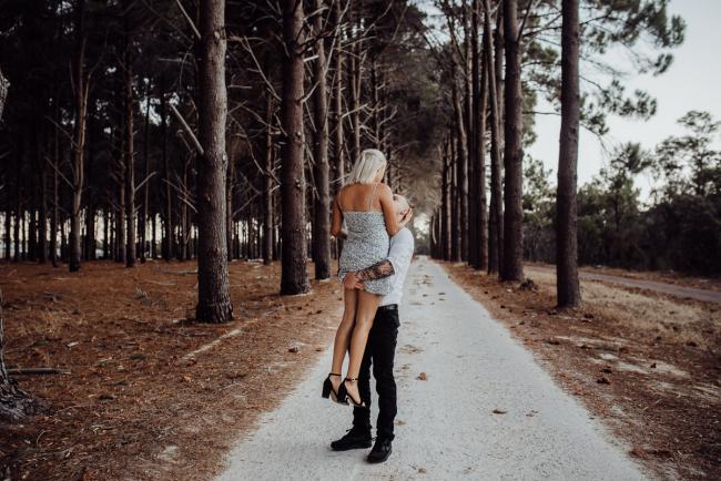 Perth-Couples-Photography-25-of-27 Man lifting his partner at The Pines Wanneroo during a Golden Hour Perth couples photography session