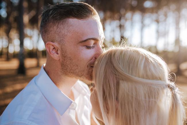 Perth-Couples-Photography-4-of-27 Close up of man closing his eyes as he kisses his partners forehead at The Pines Wanneroo during a Golden Hour Perth couples photography session