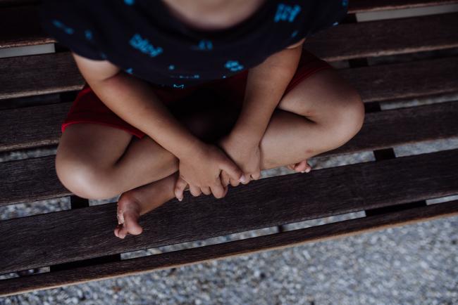 Perth-Family-Photographer-12-of-26 Top down image of little boys legs crossed on a wooden chair with family photographer Perth