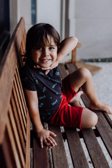 Perth-Family-Photographer-13-of-26 Little boy sitting on a wooden chair and smiling with family photographer Perth