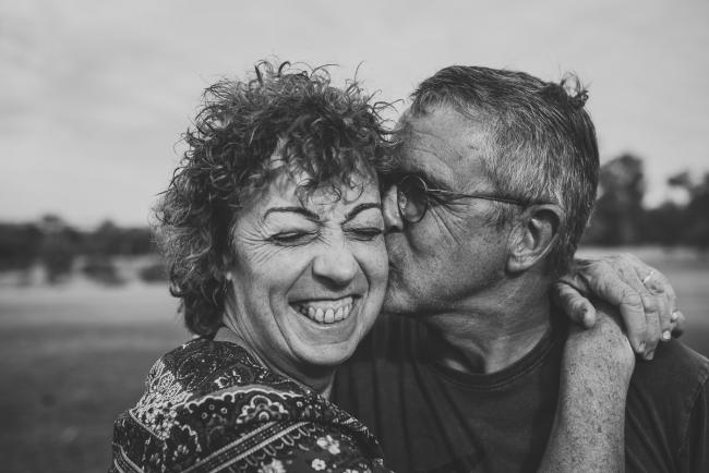 black and white image of husband kissing his wife during an extended Perth family photography session