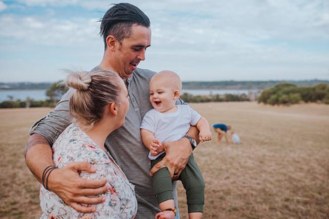 Family of 3 with the little boy smiling at his mother during a Perth extended family photography session