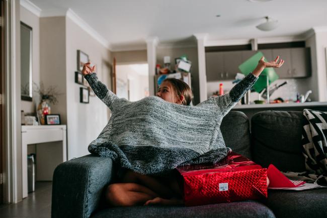 Perth-Family-Photographer-21-of-26 Girl trying on a jacket with Perth family photographer