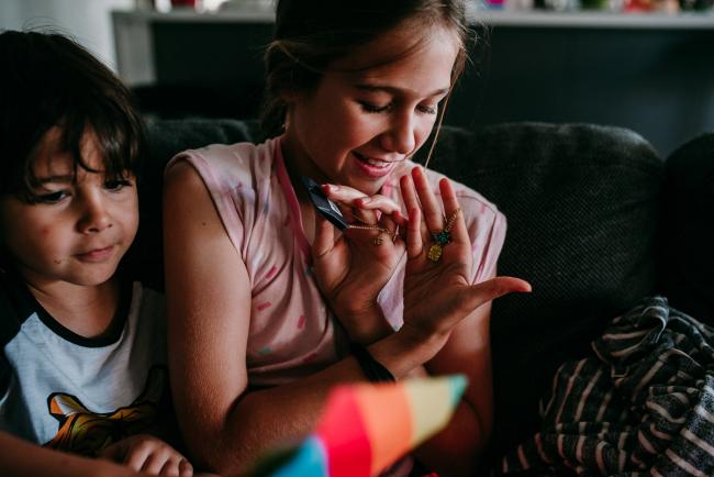 Perth-Family-Photographer-22-of-26 Girl showing a pineapple necklace in her hand with Perth family photographer