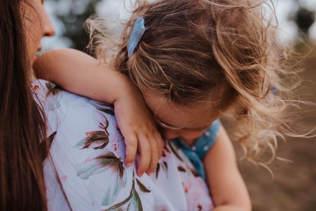 Close up of little girl resting on her mother's shoulder during a Perth extended family photography session