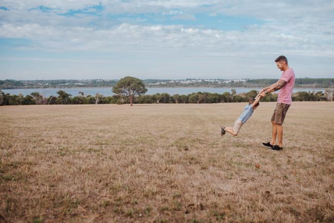Father spinning his little boy around during an extended Perth family photography session