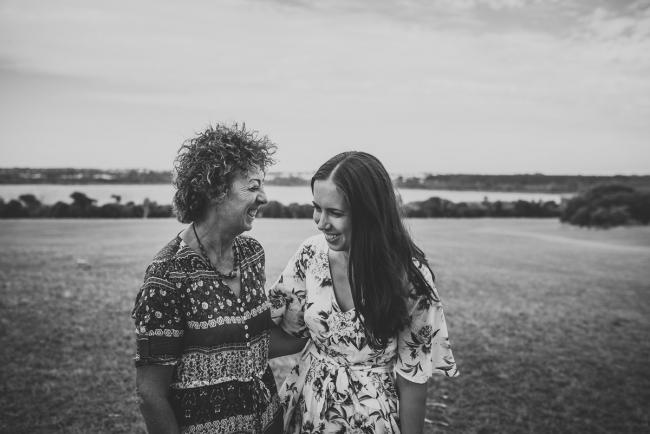 Black and white image of mother and daughter laughing together during a Perth extended family photography session