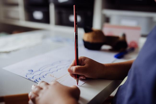 Perth-Family-Photographer-7-of-26 Close up of boy holding a pencil as he draws with Perth family photographer
