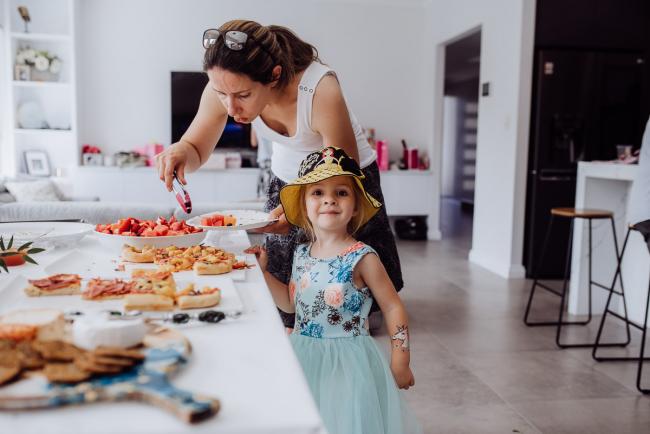 Mother and little girl getting food during a birthday party captured by Perth events photographer