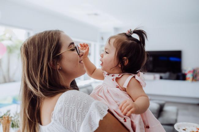 Little girl trying to steal the glasses of a woman during a birthday party captured by Perth events photographer