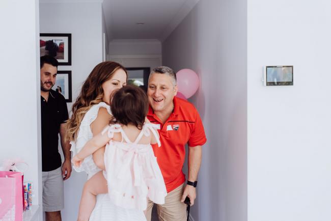 Little girl and her mother greeting a guest during a birthday party captured by Perth events photographer