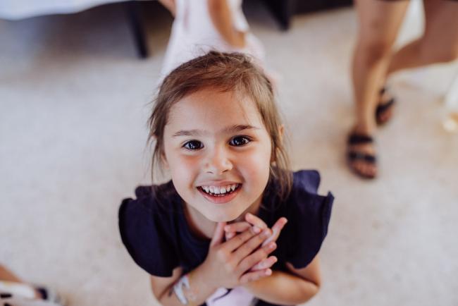 Little girl smiling up at the camera during a birthday party captured by Perth events photographer