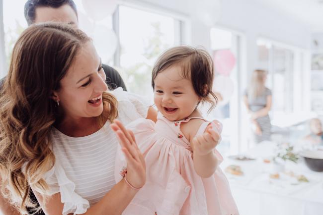 Little girl and her mother giving a high five during a birthday party captured by Perth events photographer
