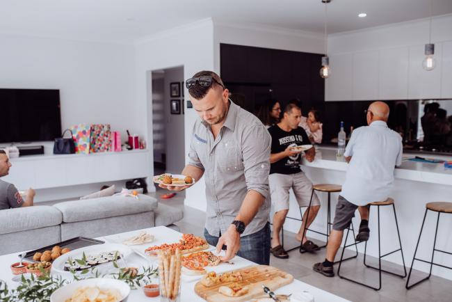 Man taking food from the table during a birthday party captured by Perth events photographer