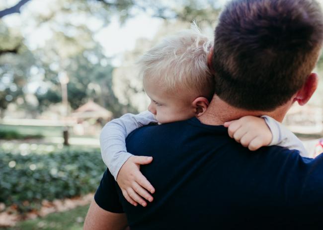Little boy cuddling his dad during a Perth maternity session at Hyde Park