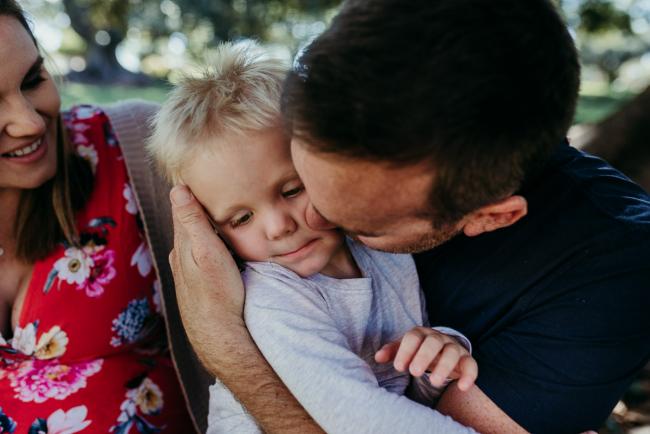 Father kissing his son during a Perth maternity session at Hyde Park