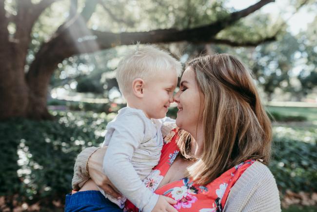 Mother and little boy touching noses with Perth family photographer at Hyde Park