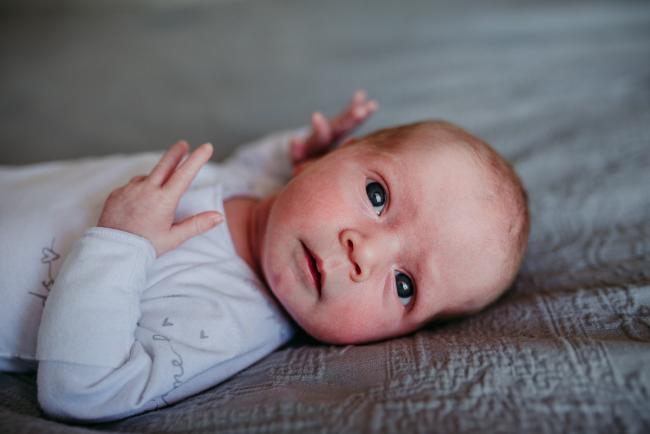Newborn-Photographer-Perth-19-of-37 Close up of newborn baby laying on the bed during a Perth newborn lifestyle session