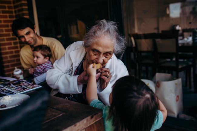 20190406-DSC_0052 Little boy reaching up to feed his great grandmother with Perth lifestyle family photographer