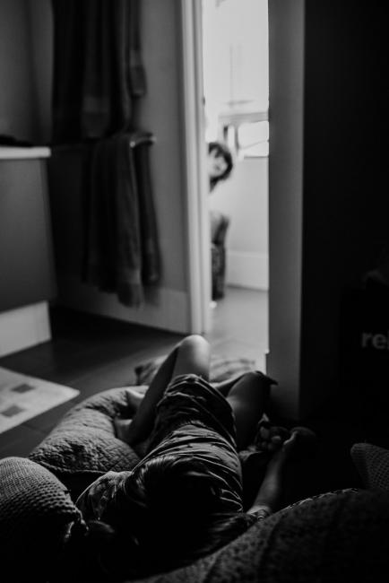 20190407-DSC_0330 Black and white image of little boy sitting on cushions as his brother is in the toilet with Perth family photographer
